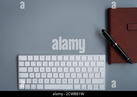 office table with computer keyboard, notebook and luxury pen. topview, copy space Stock Photo