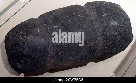 Stone pounder with grooves for the ropes which secured it to a wooden handle. Stock Photo