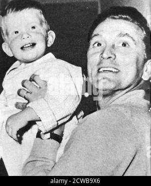 Kirk Douglas relaxing off-screen ith his son Peter. 1956. Kirk Douglas (born Issur Danielovitch Demsky; December 9, 1916 - February 5, 2020) was an American actor, producer, director, and author. Stock Photo