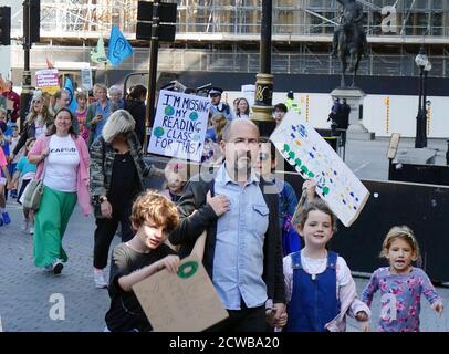 Families march past Parliament, London, during the 20th September 2019 climate strike. Also known as the Global Week for Future, a series of international strikes and protests to demand action be taken to address climate change. The 20 September protests were likely the largest climate strikes in world history. Organisers reported that over 4 million people participated in strikes worldwide, including 300000 people joined UK protests Stock Photo