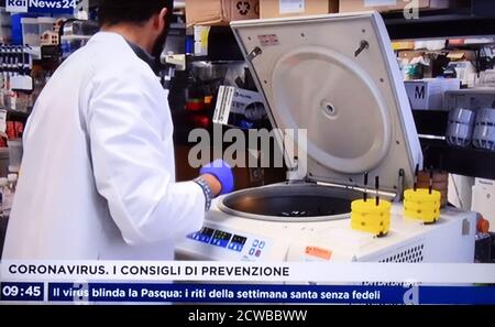 Italian TV highlights research by virologists into a vaccine during the COVID-19 pandemic. 14th March 2020 Stock Photo