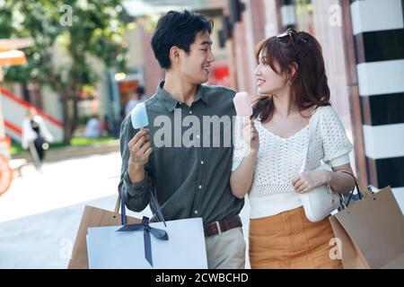 Happy couples go shopping to eat popsicles Stock Photo