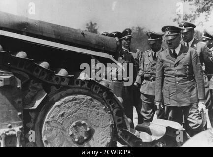 Adolf Hitler inspecting a destroyed French tank, France, World War II, 1940. Hitler is pictured during a visit to German troops occupying France after their victorious campaign in 1940. The photographer is unknown. Stock Photo