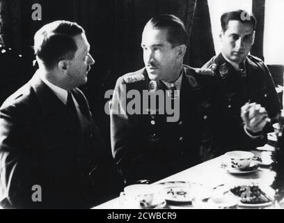 Adolf Hitler in conversation with German air force fighter ace Adolf Galland, 1941. Prior to the Second World War Galland (1912-1996) served with the Condor Legion in the Spanish Civil War. By the end of 1941, and after 94 victories, he was chosen by Hermann Goring to command Germany's fighter forces. He is pictured here in January 1941 with Hitler during a visit by the Fuhrer to the front when Galland was commander of the 26th Fighter Wing. The photographer is unknown. Stock Photo