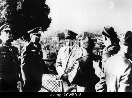 Adolf Hitler visiting the occupied city of Paris, 1940. The two officers to the left of the Nazi leader are Colonel-General (later Field Marshal) Wilhelm Keitel and Colonel Hans Speidel. Speidel would later be involved in the plot to assassinate Hitler in July 1944. He survived the reprisals after the plot and became a senior general in NATO after the war. The photographer is unknown. Stock Photo