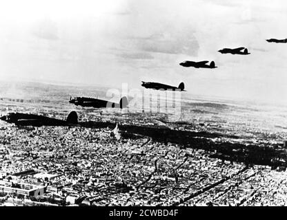 Squadron of German Heinkel He 111 bombers flying over occupied Paris, July 1940. The photographer is unknown. Stock Photo