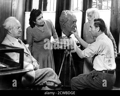 Arno Breker, German sculptor, working on a bust of Gerhart Hauptmann, 26 October 1942. Breker's was popular with several leading Nazis and Hitler in particular. He undertook numerous commissions for the regime. In 1942 he exhibited a show of his work in occupied Paris. Hauptmann was a German dramatist who won the Nobel Prize for literature in 1912. The photographer is unknown. Stock Photo