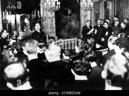 Otto Abetz, German ambassador to France, holding a press conference, Paris, 15 December 1940. He is speaking on the subject of the transfer of the body of the Emperor Napoleon II from Vienna to Paris, a gift from Hitler to the Vichy regime. On the extreme left of the photograph is Fernand de Brinon, a leading French collaborator during the Nazi occupation who was tried as a war criminal by the French after the liberation and executed in 1947. The photographer is unknown. Stock Photo