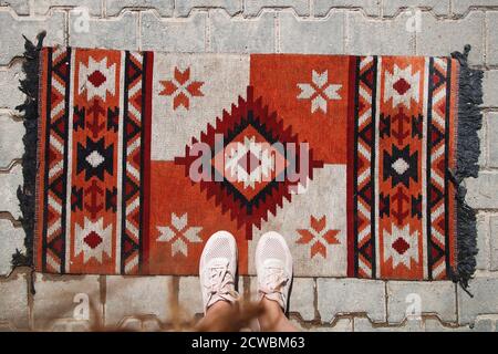 Turkey trip photo - carpet on the floor and female legs Stock Photo