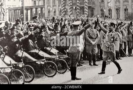 Black and white photograph of Italian leader Benito Mussolini (1883-1945) saluting soldiers in Berlin in front of the Tomb of the Unknown Soldier, September 1937. Stock Photo