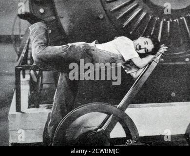 Black and white photograph of actor Charlie Chaplin (1889-1977) in a scene from the film 'Modern Times'. Stock Photo