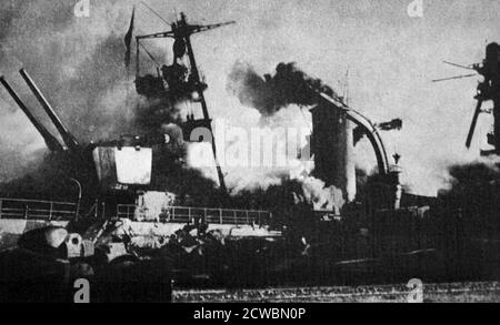 Black and white photograph of World War II (1939-1945); the intentional sinking of the French fleet in Toulon, with a photo of the French ship 'Dupleix' in flames. Stock Photo