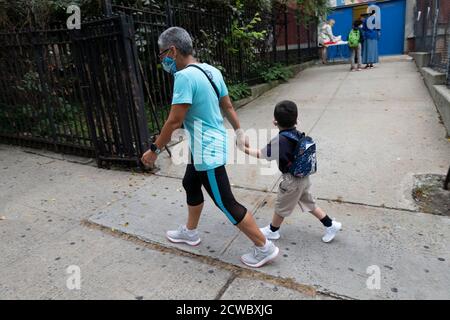 New York, USA. September 29, 2020: Parents drop of their children at PS 311 in District 9 of the Bronx Borough of New York, New York. New York opened schools up for students to return since closing last march from the Global pandemic Credit: Brian Branch Price/ZUMA Wire/Alamy Live News Stock Photo