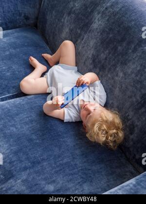 One year old baby watching youtube video on a mobile phone Stock Photo