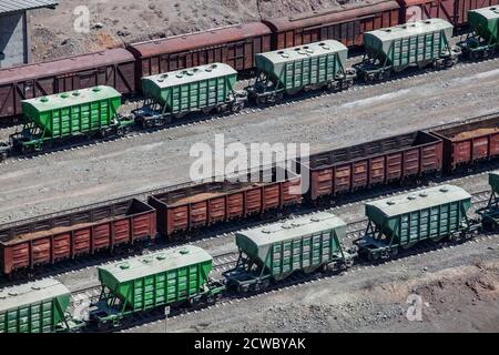 Mynaral/Kazakhstan - April 23 2012: Railroad terminal. Rail carriages hopper car on tracks. Modern cement plant in desert. Balkhash lake, Kazakhstan.