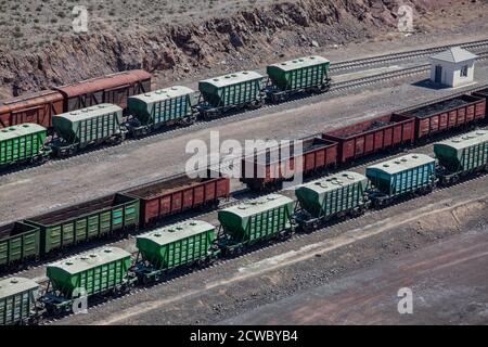 Mynaral/Kazakhstan - April 23 2012: Jambyl Cement plant. Hopper car train at loading terminal (station). Aerial view. Stock Photo