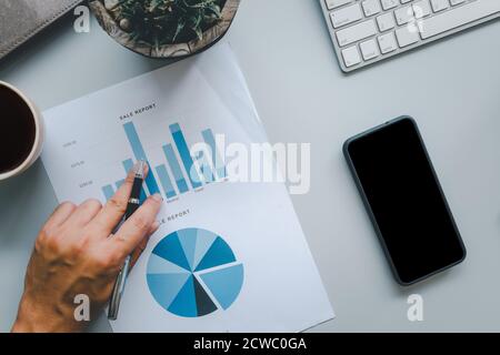 Top view of business documents, graphs and charts, and computers, notebooks and pens.Business and finance concept Stock Photo