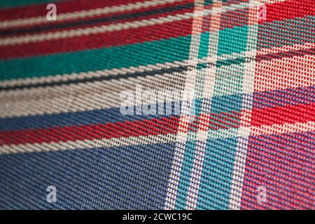 Colorful texture purple blue red turquoise from the old fabric sofa couch. Stock Photo