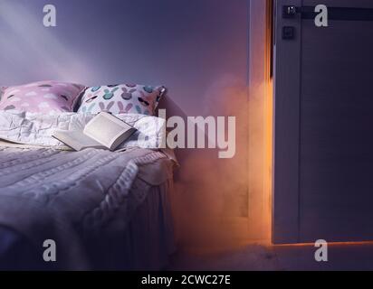 Nightmare after reading. Frightened imagination in the dark of night in bedroom. Stock Photo