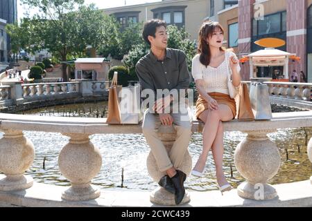 Sitting in a fountain of happy couples Stock Photo