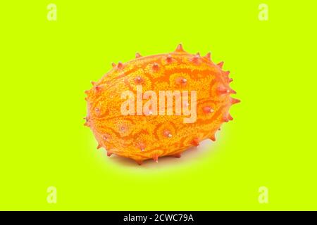 Kiwano or African horned melon isolated on green background. Hedge pumpkin, English tomato, African horned cucumber. Stock Photo