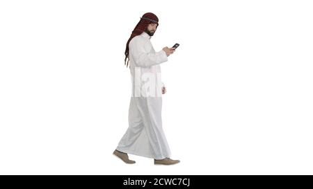 Arab man using his smartphone surfing on the internet or messagi Stock Photo