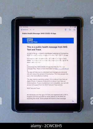 Email public health message on the screen of an IPad with details of the new NHS Trace and Test app, the NHS COVID-19 app and download instructions Stock Photo