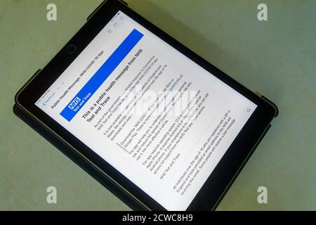 Email public health message on the screen of an IPad with details of the new NHS Trace and Test app, the NHS COVID-19 app and download instructions Stock Photo