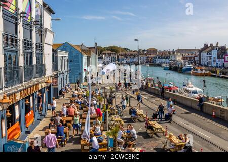 Outdoor dining at the Anchor Rendezvous pub in Weymouth, a seaside town holiday resort on the estuary of the River Wey, Dorset, south coast England Stock Photo