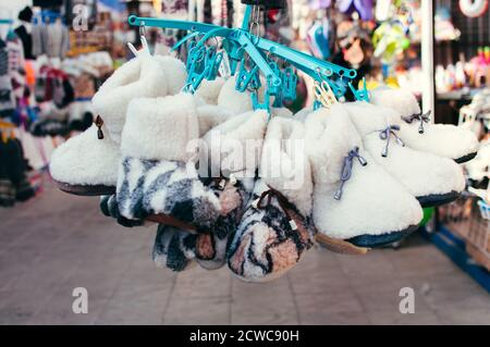 Products on the market - handmade wool slippers Stock Photo