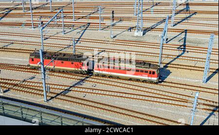 view onto a modern track system with two electric locomotives of the Austrian federal railways at the Viennese main station, Austria Stock Photo