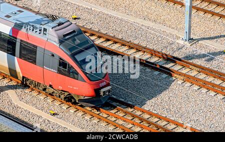 Bird's eye view onto an electric multiple unit of the Austrian public railways of the series Talent approaching the Viennese main train station, Austr Stock Photo