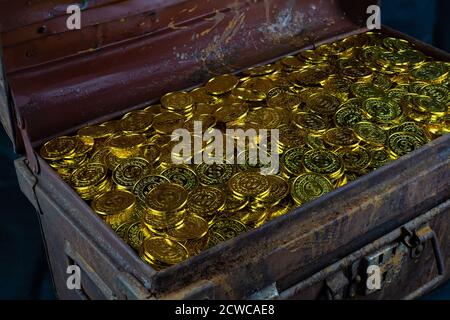 Stacking gold coin in treasure chest  on black background Stock Photo