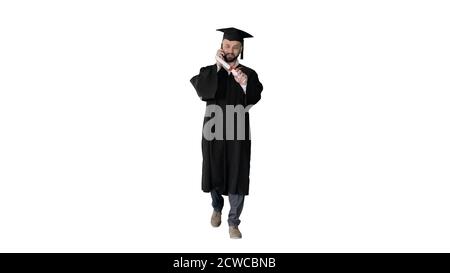 Graduating student walking and making a call on white background Stock Photo