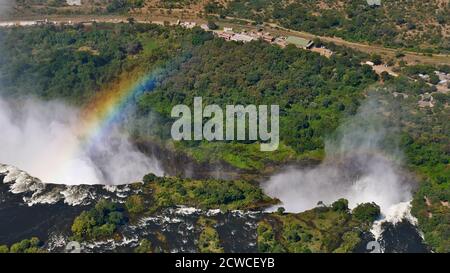 Aerial view of the majestic and powerful Victoria Falls (western part with Devil's Cataract) with rainbow from helicopter. Stock Photo