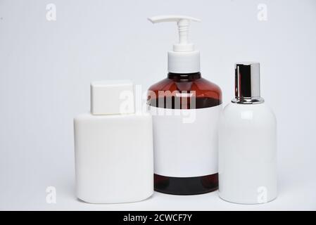 Bottles and jars with copy space on a white background. Mock up bottles. Stock Photo