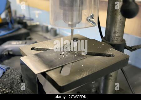 Drilling machine with a drill inserted. Metal drilling. metal shavings Stock Photo