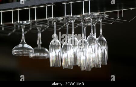 Wine glasses on the rack. Illustration on black background. Stock Photo