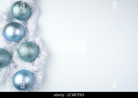 Soft blue Christmas background with toys and white tinsel on a blue background. Stock Photo