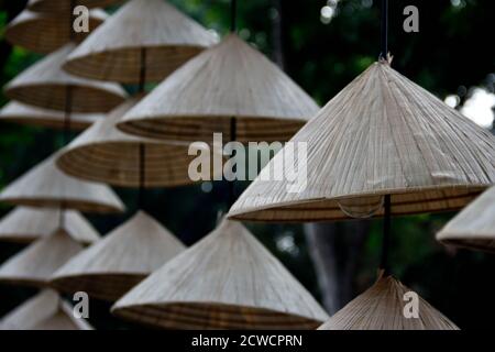 group off vietnamese leaf hats handing in a shop waiting to be sold Stock Photo