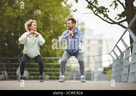 Young couple exercising during sports training outdoors in summer day Stock Photo