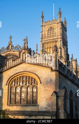 The Church of St. John the Baptist from the garden of rememberance at sunrise in autumn. Cirencester, Cotswolds, Gloucestershire, England Stock Photo