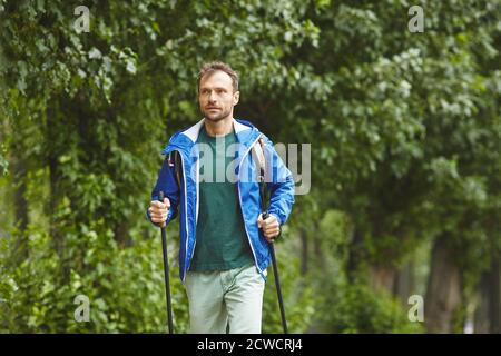 Young healthy man walking outdoors in the forest Stock Photo