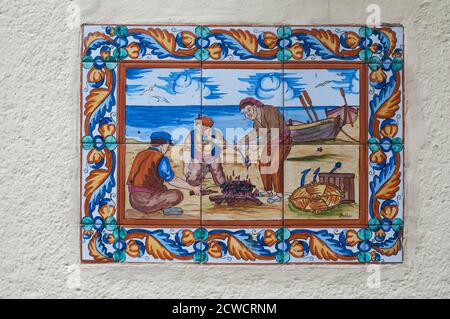 BARCELONA, SPAIN - JUNE 2, 2013: Picture of a mosaic depicting the fisher in Spain. An image of specially painted tiles and pieces of glaze on the Stock Photo