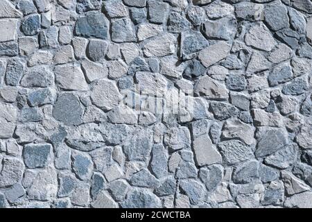 An unusual wall of wild stone blue. Background. High quality photo Stock Photo