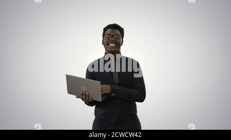 Confident African American businessman typing on laptop and look Stock Photo