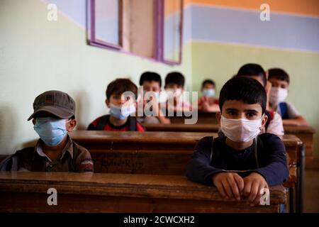 September 28, 2020: Idlib, Syria. 28 September 2020. Children return to school at the beginning of the new academic year observing some precautionary measures to avoid the spread of the Coronavirus. There has been a relatively low number of Covid-19 infections and deaths in the opposition- controlled areas in northwestern Syria, as they have remained isolated from surrounding territories. Yet, a major virus outbreak would constitute a catastrophe in the devastated region, with its high population density, the congestion in camps, the lack of basic infrastructures, and a shattered health care s