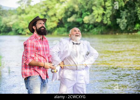 Bearded man and elegant businessman fishing together. Fishing skills. Set  up rod with hook line and sinker. Fishing and drinking beer. Men relaxing  Stock Photo - Alamy