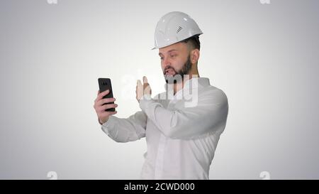 Man engineer wearing protecting safety helmet and shirt making v Stock Photo