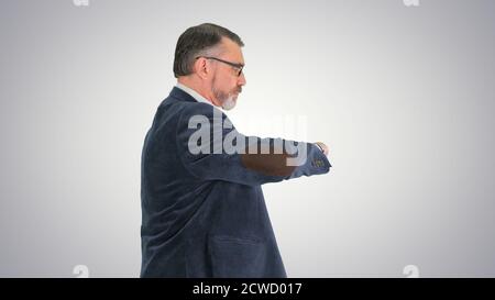 Smart business man in glasses looking at watch and walking quick Stock Photo